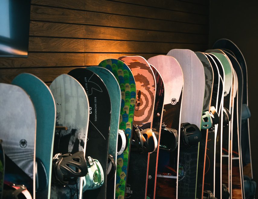 Row of colorful snowboards on display in the Escape Myoko rental shop